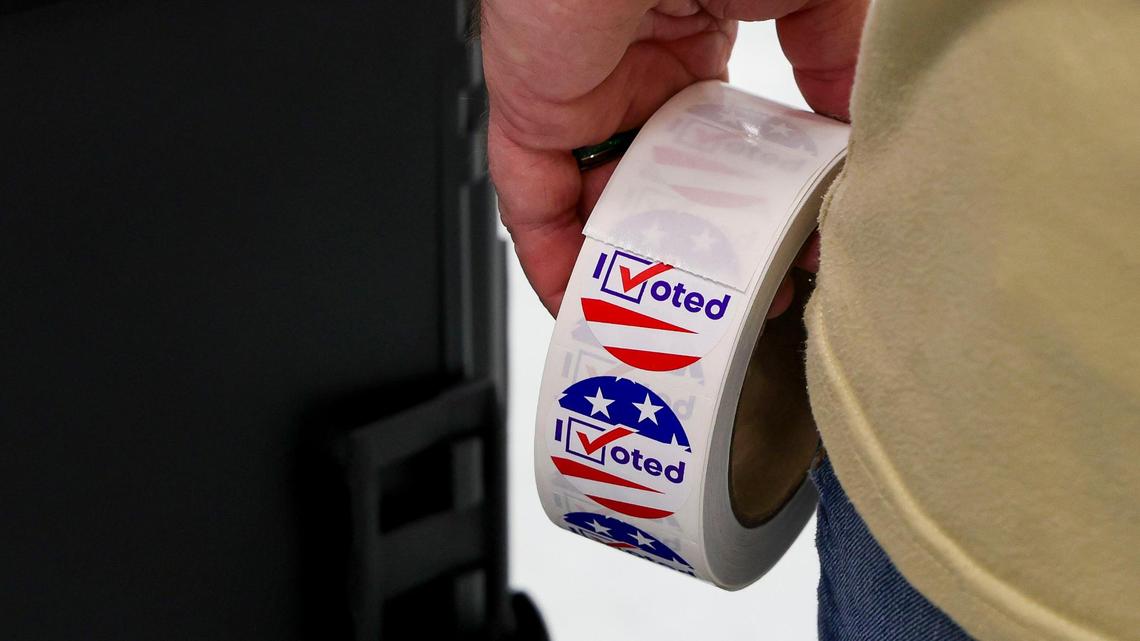 A precinct worker at Lansdowne Elementary School holds a roll of “I Voted” stickers as voters cast their ballots in the 2024 General Election at Lansdowne Elementary School, Tuesday, Nov. 5, 2024, in Lexington, Ky.