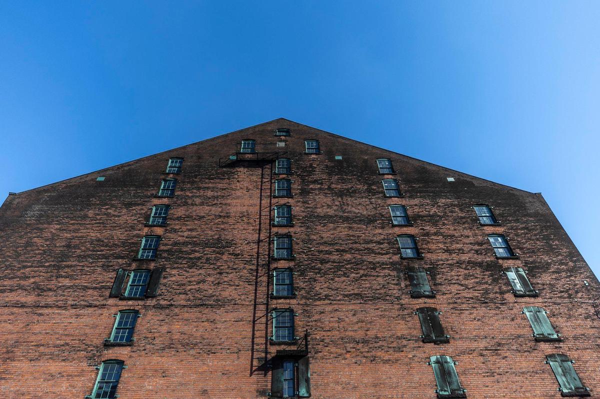 A warehouse is photographed at Buffalo Trace Distillery in Frankfort, Ky., on Wednesday, Jan. 15, 2025. The black on the bricks is whiskey fungus.