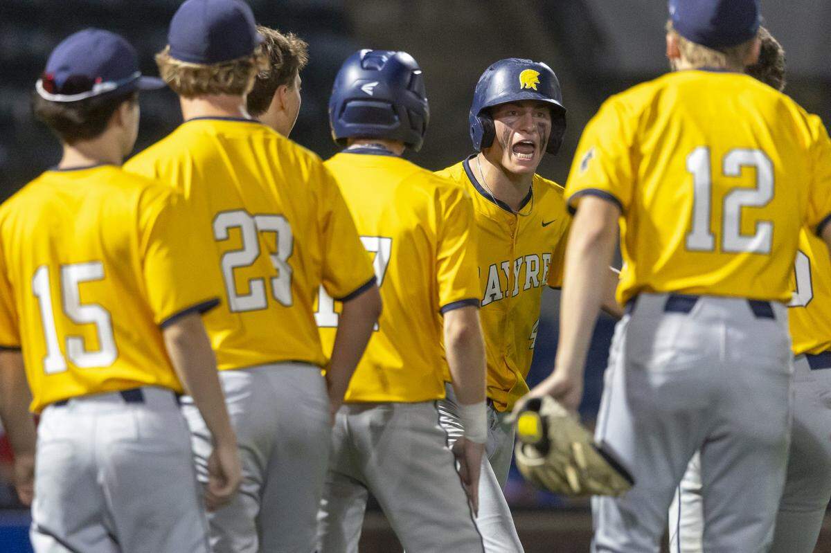 Sayre's Banks Heinrich (4), fifth from left, celebrates with his teammates after scoring in a game against Madison Central during Kentucky high school baseball's 11th Region Tournament semifinals at Lexington Legends Park in Lexington, Ky., on Wednesday, May 27, 2026.