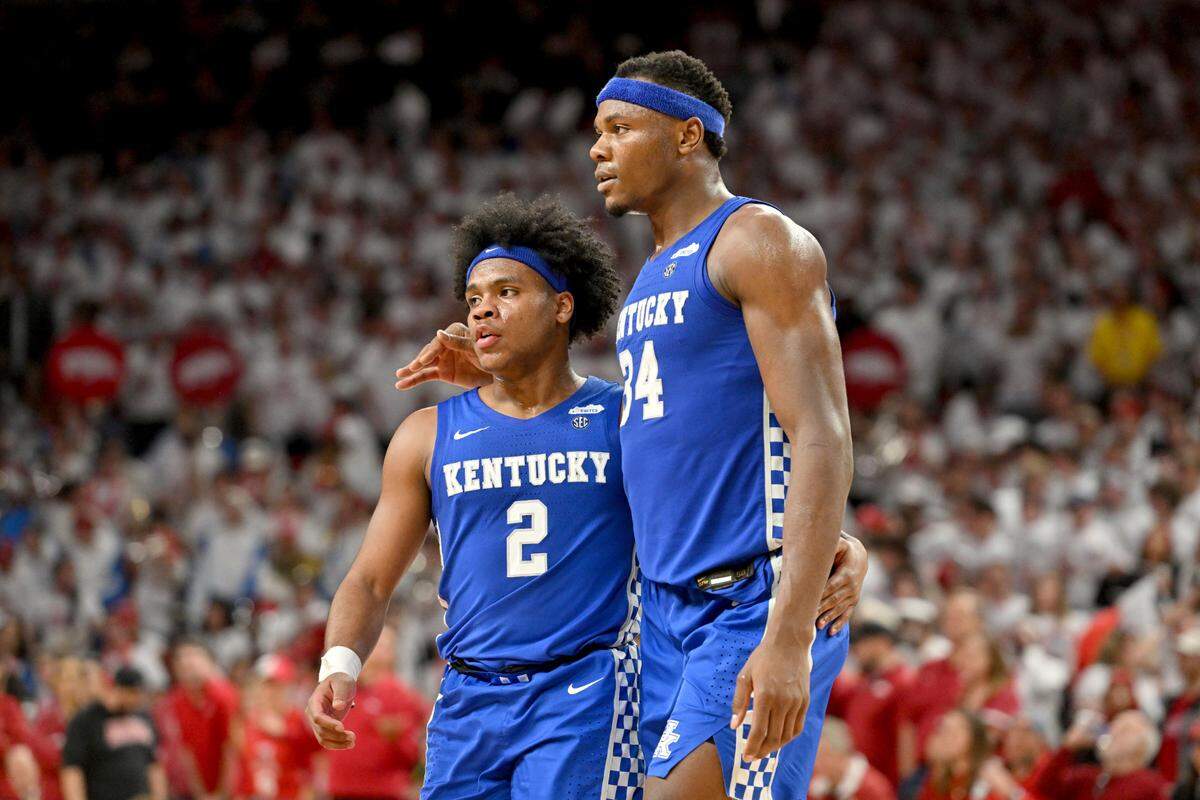Kentucky players Sahvir Wheeler (2) and Oscar Tshiebwe (34) head to the bench during a time out against Arkansas on Feb. 26 in Fayetteville.