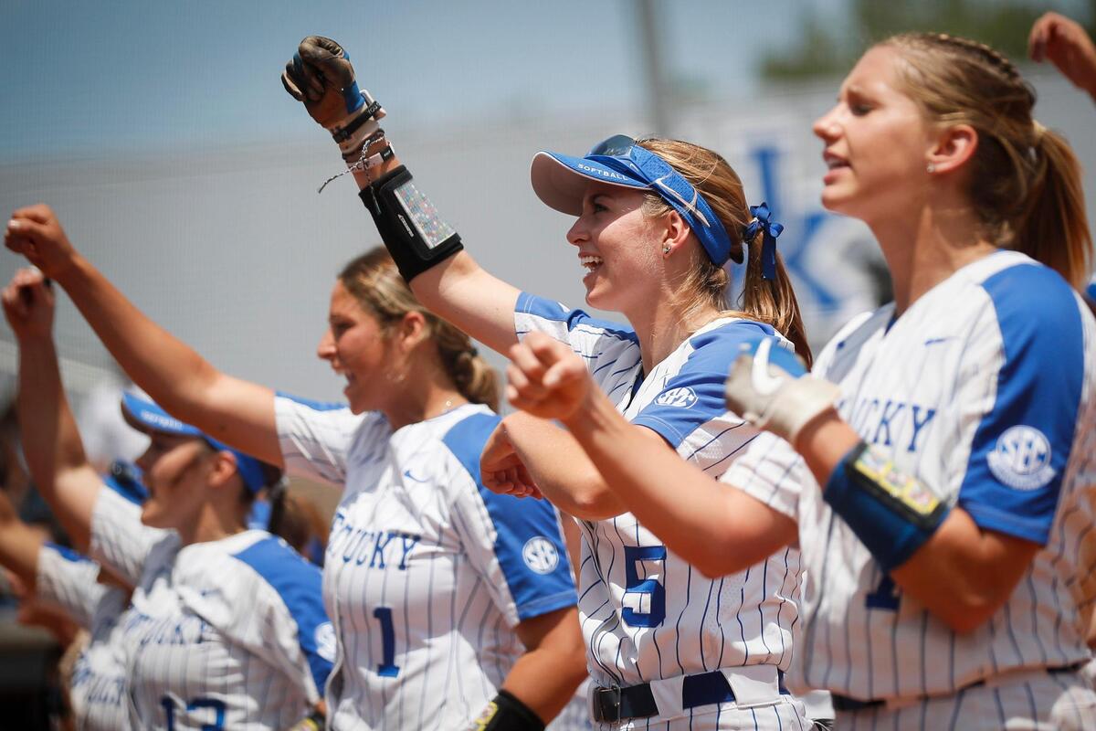 Kentucky players Miranda Stoddard (1), Tatum Spangler (5) and Autumn Humes (7), along with other members of the team, rallied with the crowd after defeating Northwestern 3-2 on Friday.