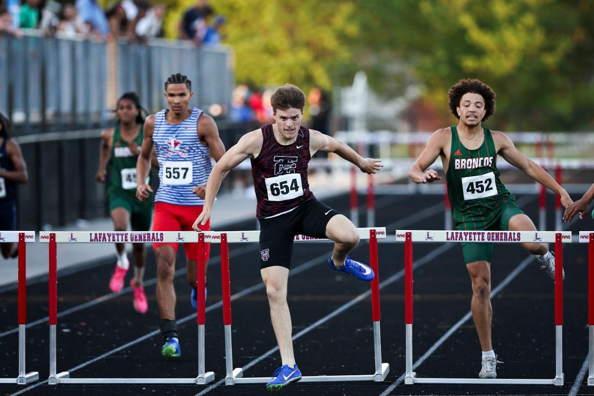 Andrew Witherington, center, won the 300-meter hurdles and took part in a pair of winning relays for Tates Creek on Tuesday night.