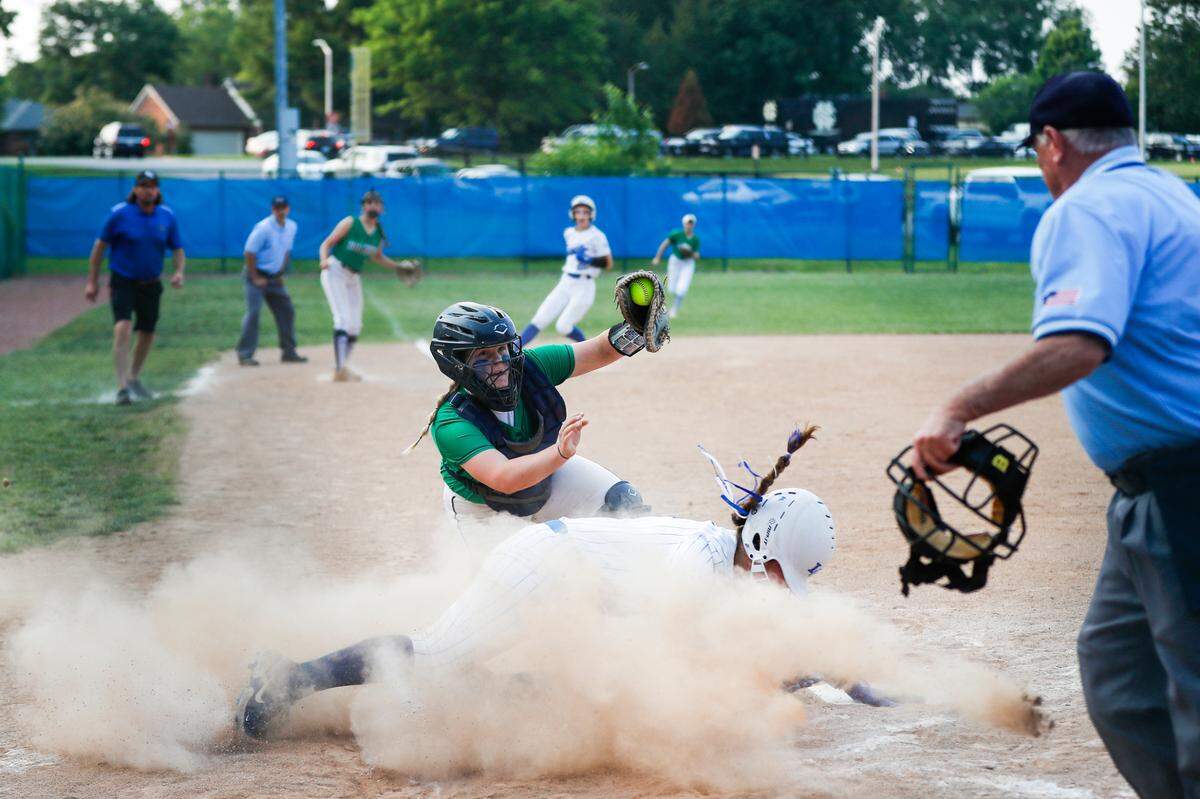 Lexington Catholic Abby Hammond (4) is tagged out sliding into home plate by Great Crossing’s Kendall Meade (33) during the Region 11 softball championship at Henry Clay High School in Lexington, Ky., Wednesday, May 24, 2023. Great Crossing trailed defending state runner-up Lexington Catholic by two runs in the top of the seventh inning but came back to win, 3-2 in eight innings.