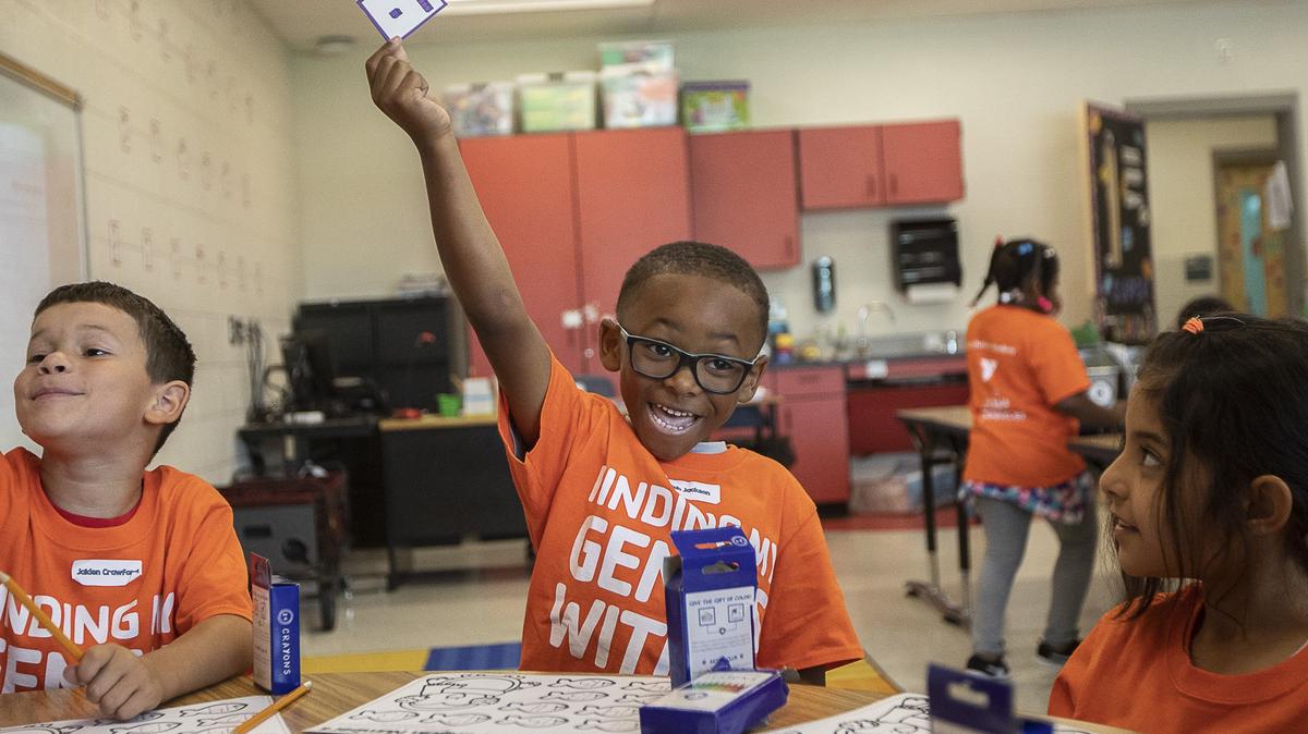 Elijah Jackson, a rising first-grade student, holds up a card while practicing number skills during the YMCA of Central Kentucky’s Power Scholars Academy at Coventry Oak Elementary School Wednesday, June 19, 2019.