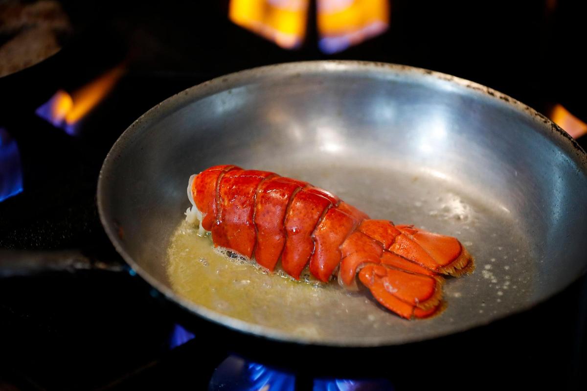 A lobster tail is sauted before being added to the “Boss Platter” at Mr. Krabs & Bean’s BBQ in Lexington, Ky., Thursday, Nov. 19. 2020.