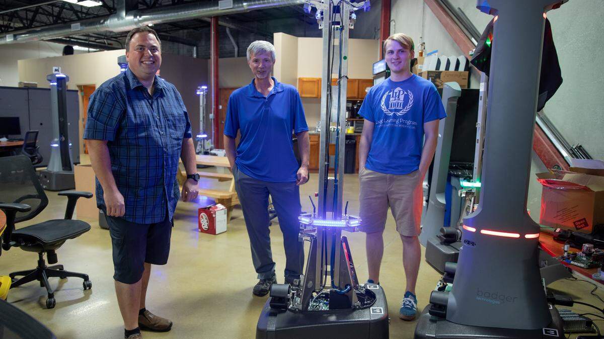 Al, the robot, with (left to right): Andrew C. Martin, senior software engineer; Tim Rowland, Badger Technologies CEO; Austin Herman, University of Kentucky intern/software engineer.