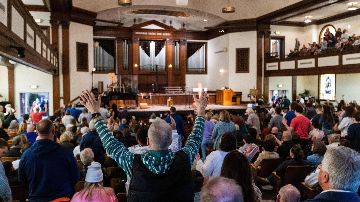 Students and visitors fill Hughes Auditorium at Asbury University singing with musicians on stage for the sixth consecutive day of a revival, February 14, 2023, which began when students stayed past normal chapel service on February 8 to continue nonstop prayer. The revival has garnered visitors from other parts of the country arriving in cars and busses to pray and sing in the auditorium.