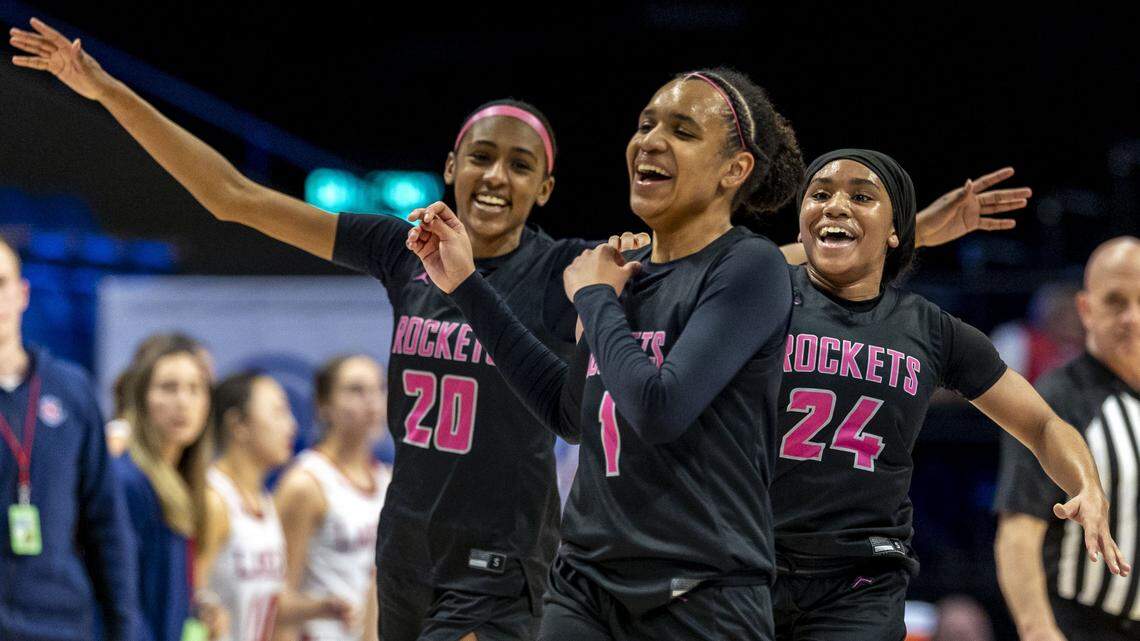 Assumption's Ava Moore (1), center, celebrates with Assumption's Kylie Moore (20), left, and Assumption Serae Bundrent-Palmer (24), after Ava Moore scored her 1,000th career point during the Rocket's 72-35 win over Calloway County in a first-round game against Calloway County in the 2026 Clark's Pump-N-Shop Girls' Basketball Sweet 16, Wednesday, March 11, 2026 at Rupp Arena in Lexington, Ky.