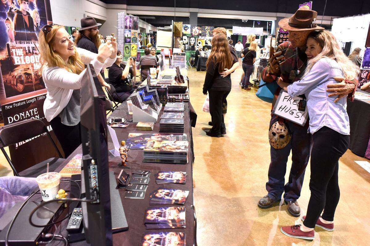 Casi Benedict of Owensboro-based Red Serial films takes a picture of her colleague Mercedez Varble with Bruce Thompson of Columbus, Ga., who was dressed as “Nightmare on Elm Street” villain Freddy Krueger, at ScareFest 2017.