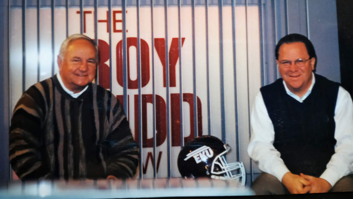Longtime Eastern Kentucky University radio play-by-play announcer Greg Stotelmyer, right, also frequently served as host of EKU coaches’ shows, including with the iconic Roy Kidd, left, who coached the Colonels football team from 1964 through 2002.