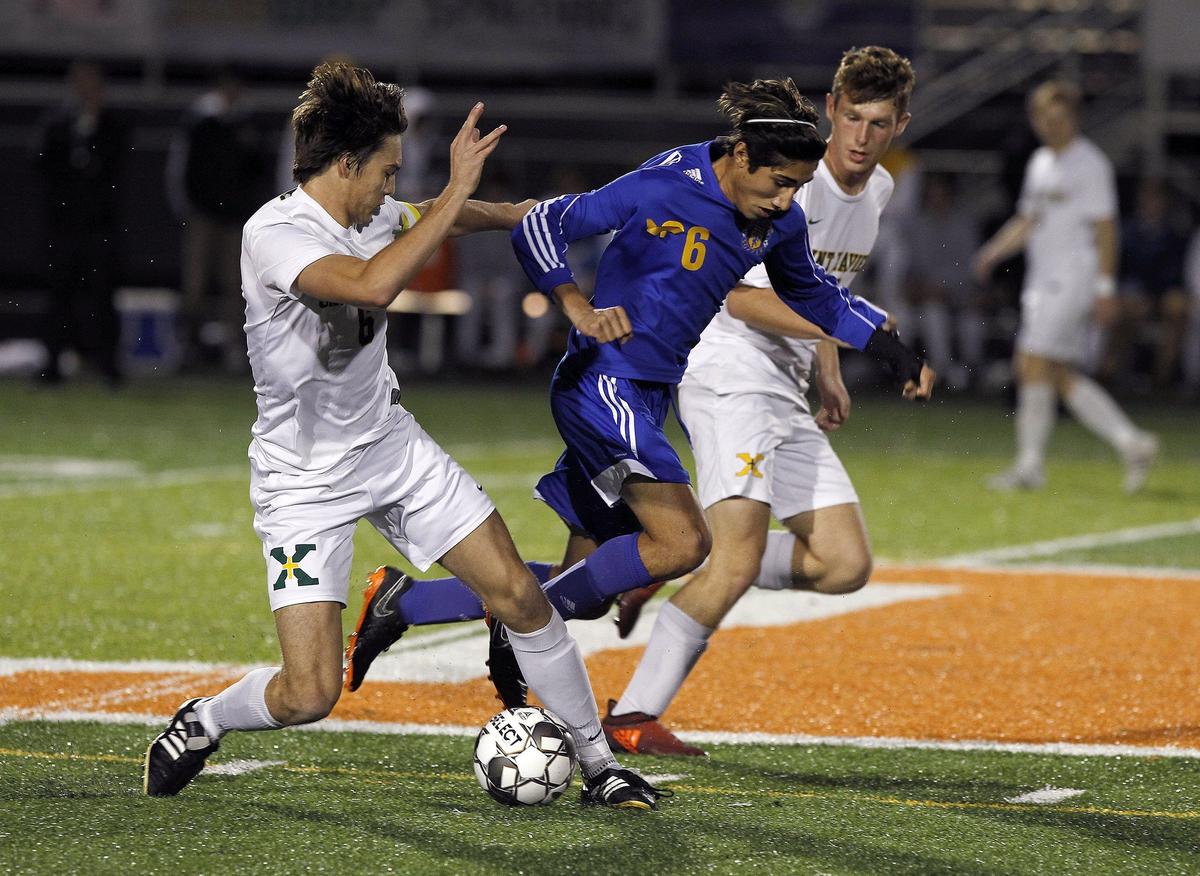 Henry Clay’s Markeius Hill dribbled through St. Xavier defenders Thursday evening in the KHSAA boys’ soccer state semifinals.