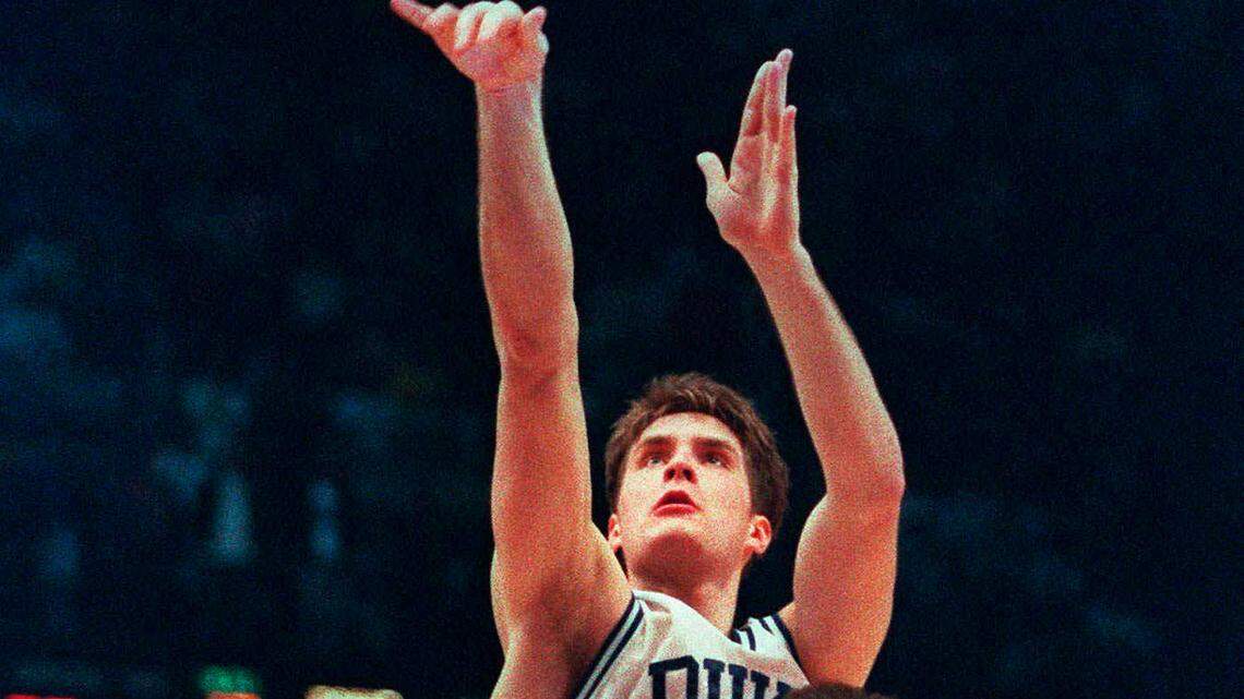 Duke's Christian Laettner shoots the game-winning basket in overtime over University of Kentucky's Deron Feldhaus to win the NCAA East Finals in Philadelphia March 28, 1992. Duke beat Kentucky 104-103. (AP Photo/Charles Arbogast)