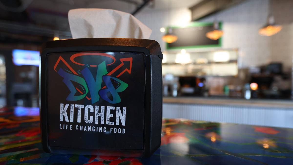 Tables in the new DV8 Kitchen location on the corner of East Third and Midland were painted by local non-profits and organizations involved in addiction recovery.