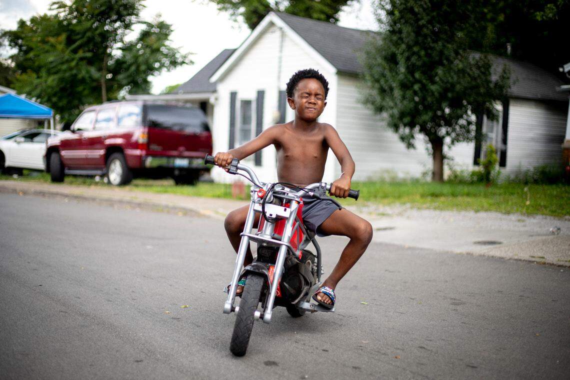 De-jior Moberly, 6, drives an electric motorcycle down the street in front of his house with his eyes closed in Lexington, Ky., Thursday, July 9, 2020. Moberly’s mother Sandra Smith said he has been obsessed with motorcycles since he was 3.