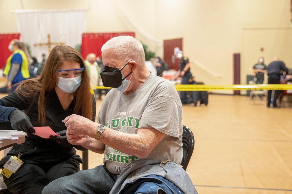 Christine Said spoke to Robert Moyer, of Lexington, after administering the COVID-19 vaccine to him during a Lexington-Fayette County Health Department vaccination clinic at Consolidated Baptist Church Wednesday.