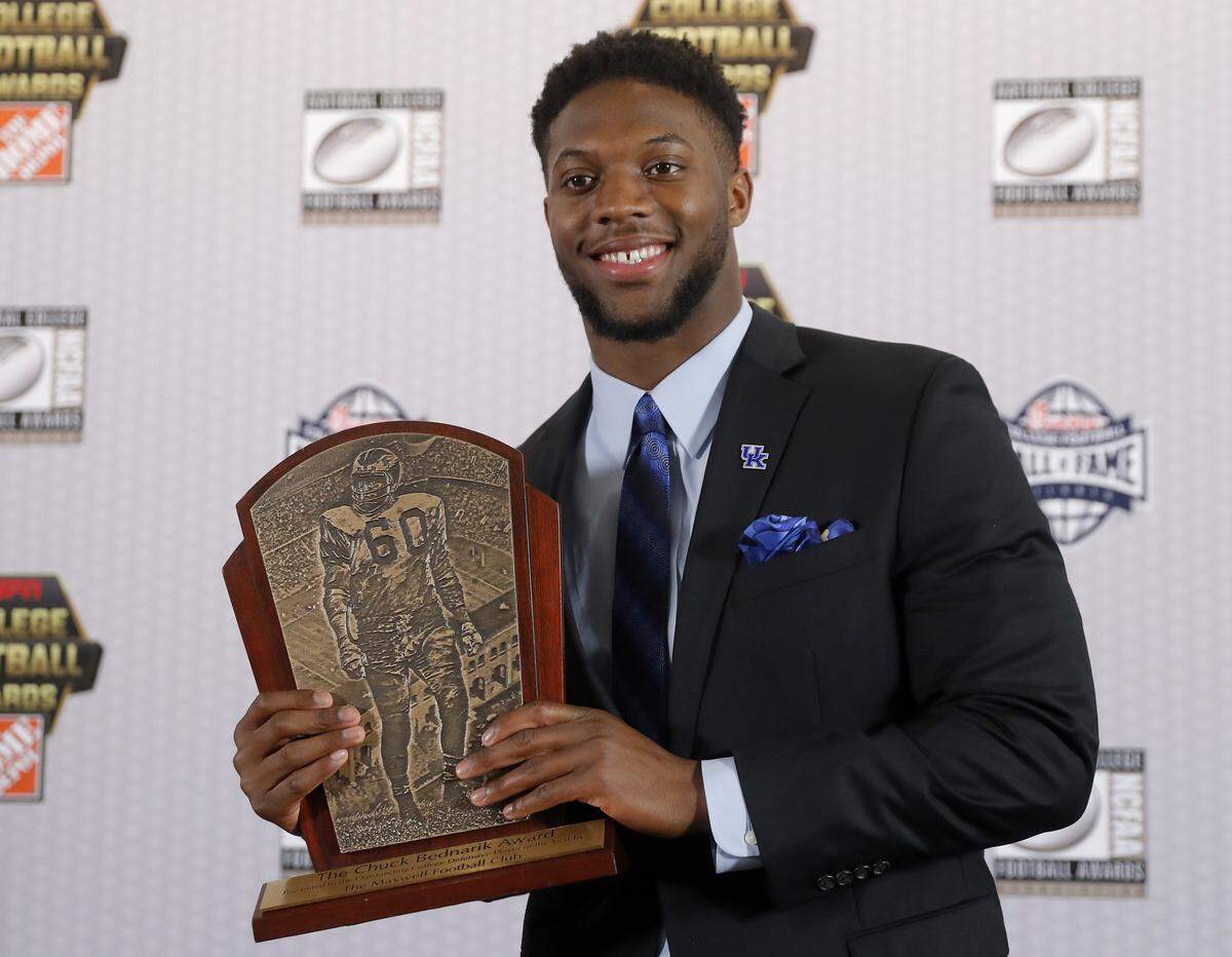 Kentucky’s Josh Allen poses with the trophy after winning the Chuck Bednarik Award as college football’s top defensive player of the year, Thursday, Dec. 6, 2018, in Atlanta. (AP Photo/John Bazemore)