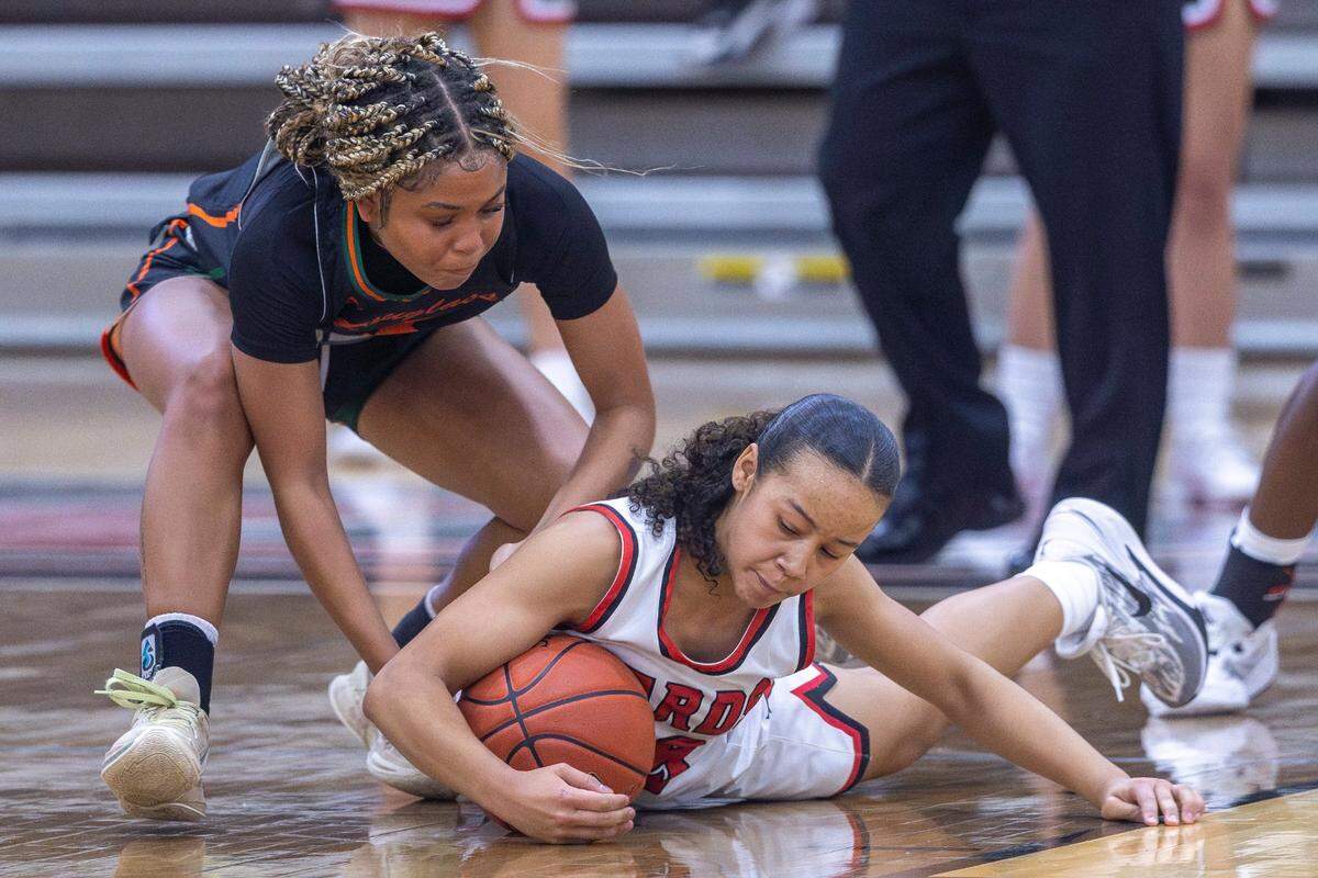 Frederick Douglass’ Niah Rhodes, left, fights for a loose ball with George Rogers Clark’s Anaya Chestnut during a game in Winchester on Dec. 15, 2023.