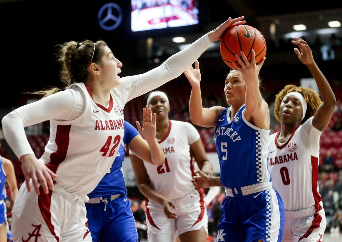 Alabama forward Meg Newman (42) and Kentucky guard Cassidy Rowe (5) battle for a rebound Sunday. The Crimson Tide outrebounded the Wildcats 47-29.