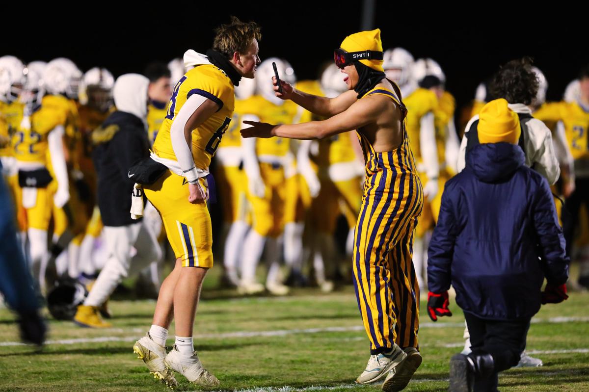 Sayre’s student section joins in the celebration on the field after Friday night’s historic Spartans victory.