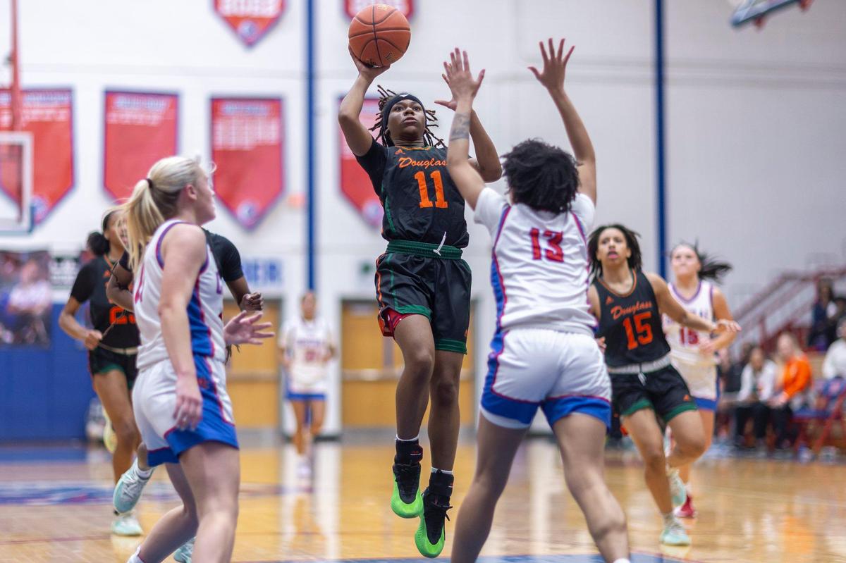 Frederick Douglass’ Mikalee Bennett (11) shoots over Madison Central’s Jordynn Miles during the Broncos’ 64-58 win over the Indians at Madison Central High School in Richmond on Friday.