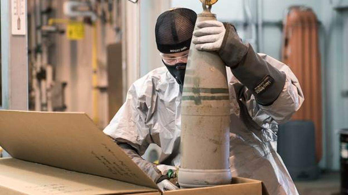 A munitions handler placed a projectile containing mustard agent into a box to begin the destruction process in the Static Detonation Chamber at the Blue Grass Chemical Agent-Destruction Pilot Plant. The Blue Grass Chemical Stockpile Outreach Office said a portion of this photograph was “blurred in accordance with Department of Defense guidelines.”