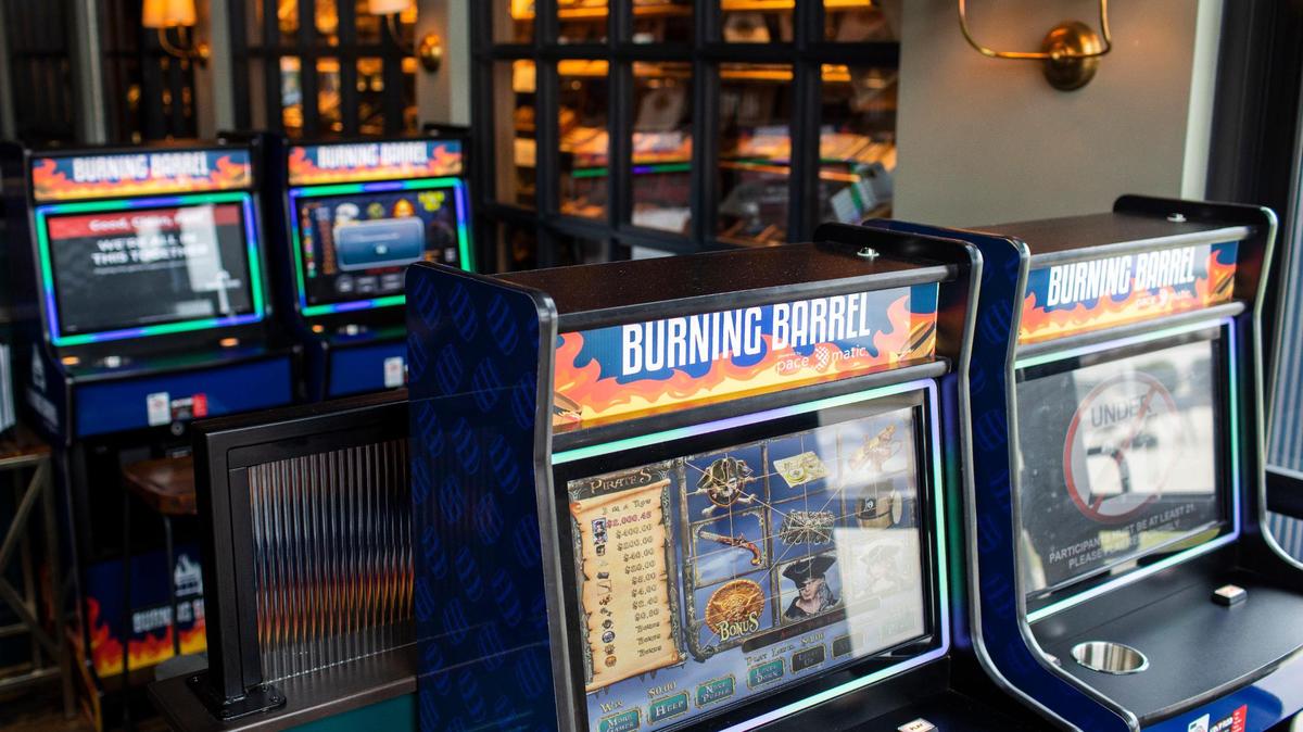 Unregulated slot machines are flooding Kentucky. And police are helping, for a cut.