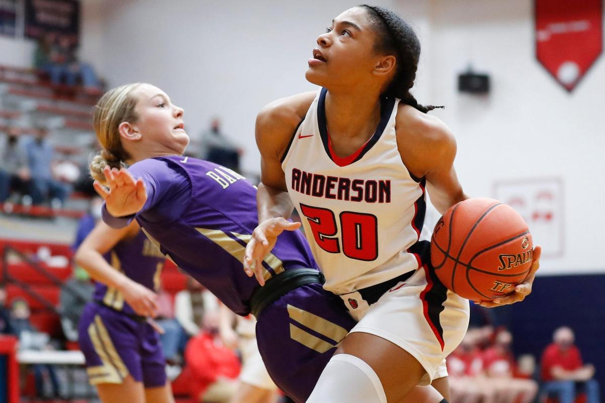 Anderson County’s Amiya Jenkins (20) drove against Bardstown’s Kadence Walls (12) in Lawrenceburg on Friday night. Jenkins scored 10 of her 12 points in the second half after battling first-half foul trouble.