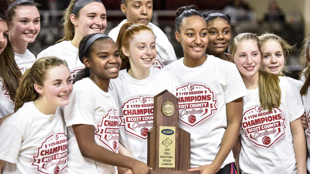 Scott County celebrated with the championship trophy after beating Henry Clay 82-42 in the finals of the 11th Region Tournament.