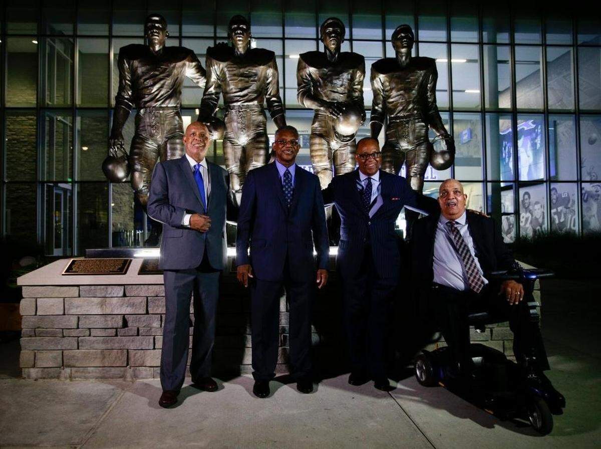 In 2016, the University of Kentucky unveiled statues of the four football players who broke the SEC color barrier from left: Mel Page, representing his late brother Greg Page; Nate Northington; Wilbur Hackett and Houston Hogg.