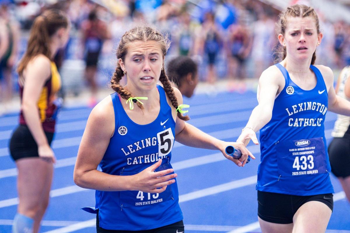 Lexington Catholic’s Caroline Beiting, center, receives the baton from her teammate during the Knights’ 4 by 400-meter relay victory at the Class 2A track and field state championships.