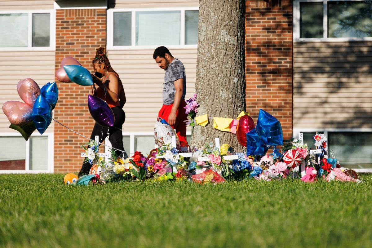 Members of the community and FaithPointe Church created a memorial during a vigil on Monday, May 9, 2022, at Parkway Plaza Apartments in Lexington, Kentucky, for Skyler Williams, 5, and Deon Williams, 13, who were killed last week. Their mother has been accused of killing the two children.