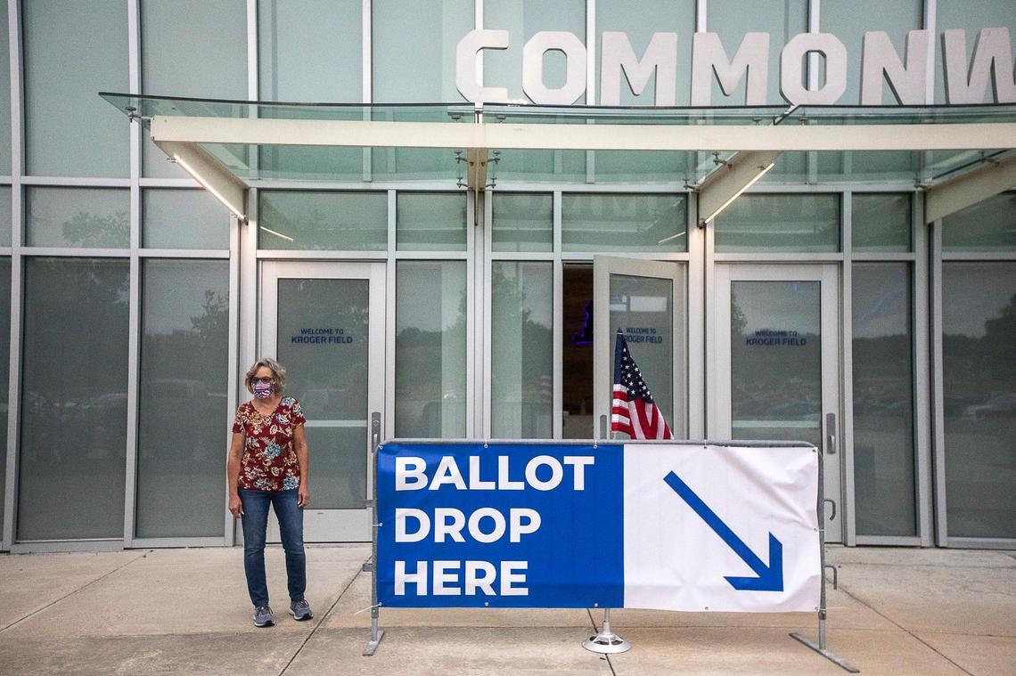 Poll worker Dolores Louallen directs Fayette County voters where to drop off their absentee ballots at Kroger Field in Lexington, Ky., on Tuesday, June 23, 2020.