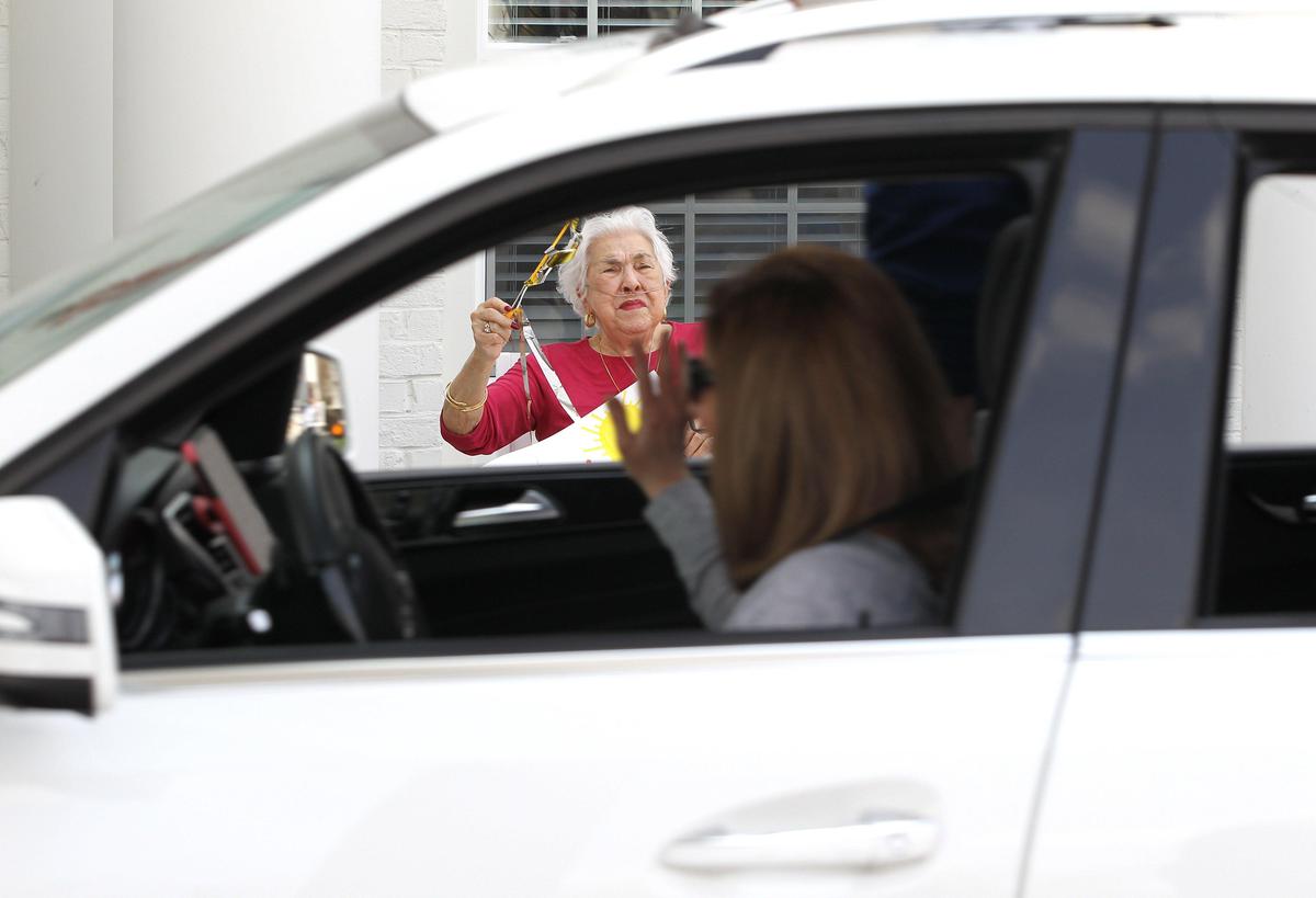 Rose Marie Farah waved to members of Immanuel Baptist Church as they staged a drive by parade Friday for residents of Highgrove at Tates Creek senior living community.