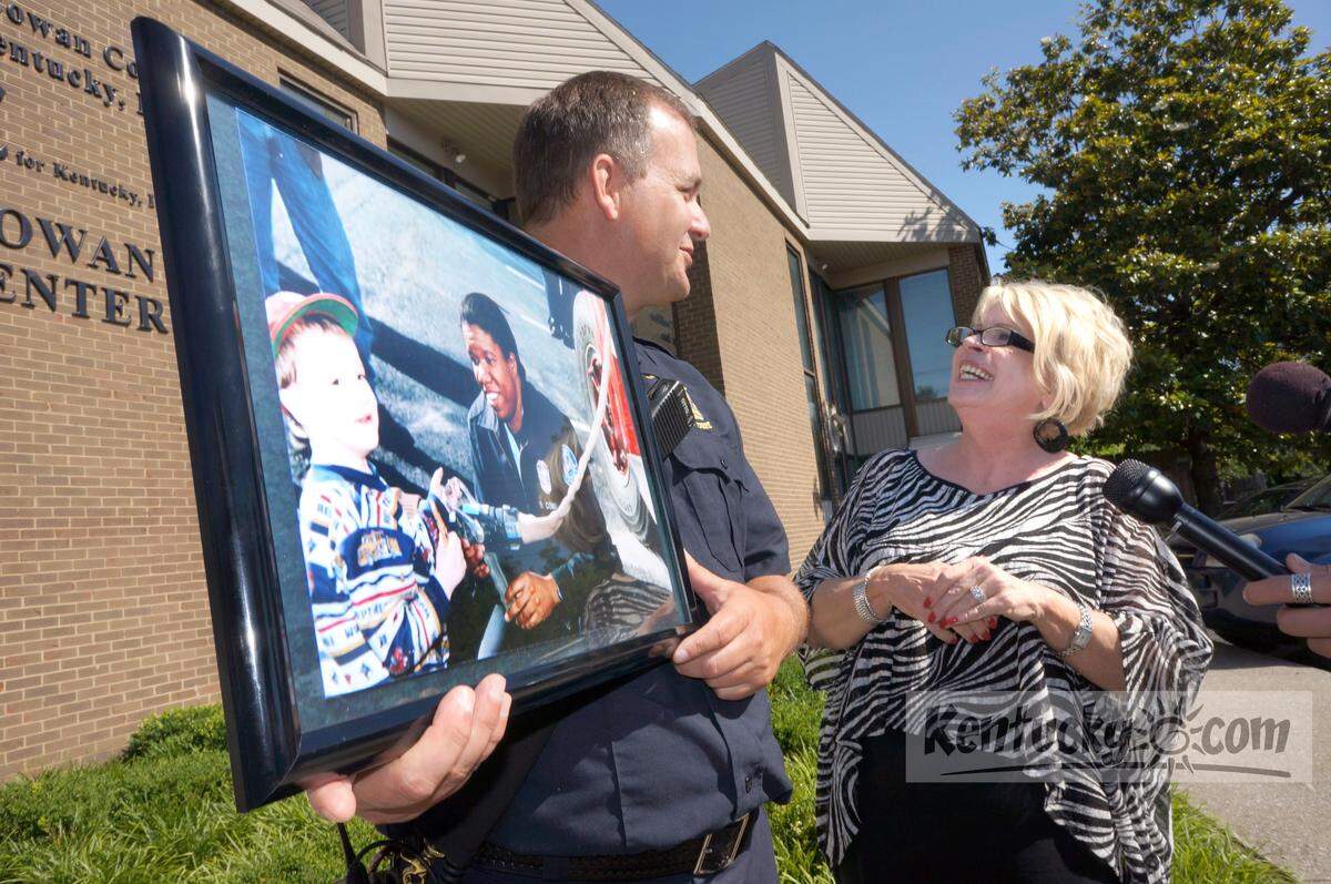Division of Fire Major Mike Runnels talks with Karen Trivette, executive director of the coalition at the Brenda D. Cowan Coalition for Kentucky, Inc. on Thursday, June 7, 2012 at a news conference in Lexington. Firefighters presented the coalition with a recently discovered candid photo of Lt. Cowan, who was shot and killed in 2004 when responding to a fire call. Photo by David Perry | Staff