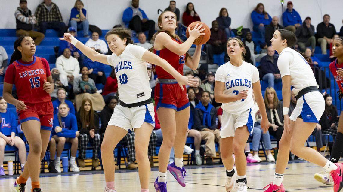 Lafayette’s Anna Clay Denton, center, goes up for a basket against Lexington Christian’s Payton Buckler in the middle of a crowd of players, including Lafayette’s Addi Combs (15) and LCA’s Jentry Bertram (34) and Piper Graham, during the Generals 45-37 win at Lexington Christian Academy on Monday.