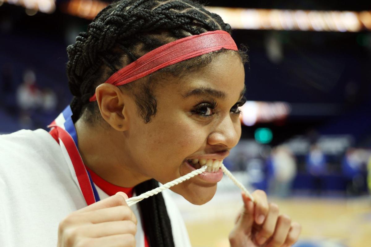 Sacred Heart’s ZaKiyah Johnson (11) celebrated with a piece of game net after the Valkyries won the Girls’ Sweet 16 state championship game in Rupp Arena last March. Johnson will play college basketball at LSU after trying to lead SHA to a record fifth straight state title.