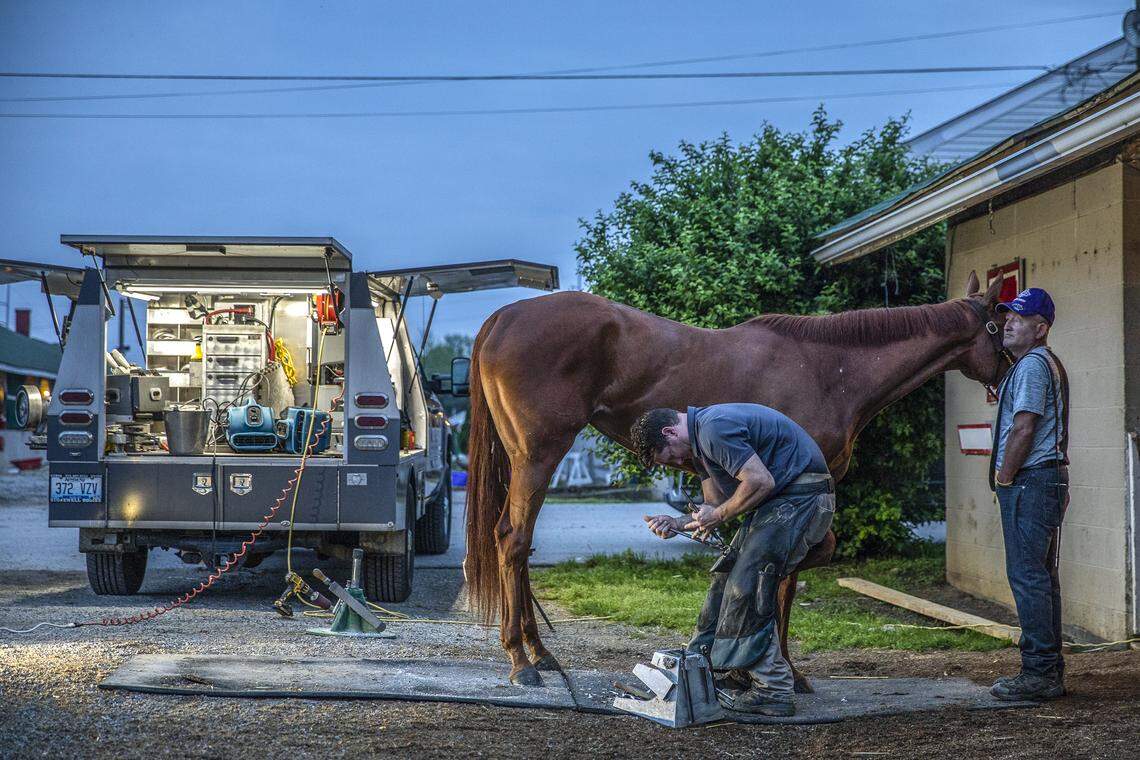 Ferrier Chris Broadus shows a horse in the barn area at Churchill Downs early in the morning on Saturday, May 4, 2019.