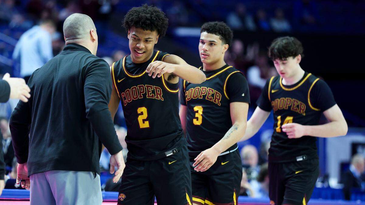 From left, Cooper head coach Tim Sullivan greets Isaac Brown (2), Jaidan Combs (3) and Andy Johnson (14) as they come off the court late during Cooper’s 50-35 win over Henderson County on Thursday night. The trio combined for 39 of Cooper’s 50 points.