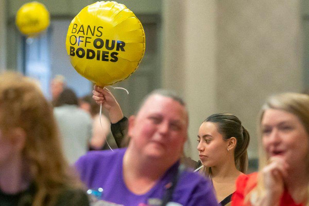 Sarah Gonzalez of Louisville holds a balloon at Protect Kentucky Access’ election watch party the Galt House in Louisville, Ky., on Tuesday, Nov. 8, 2022.