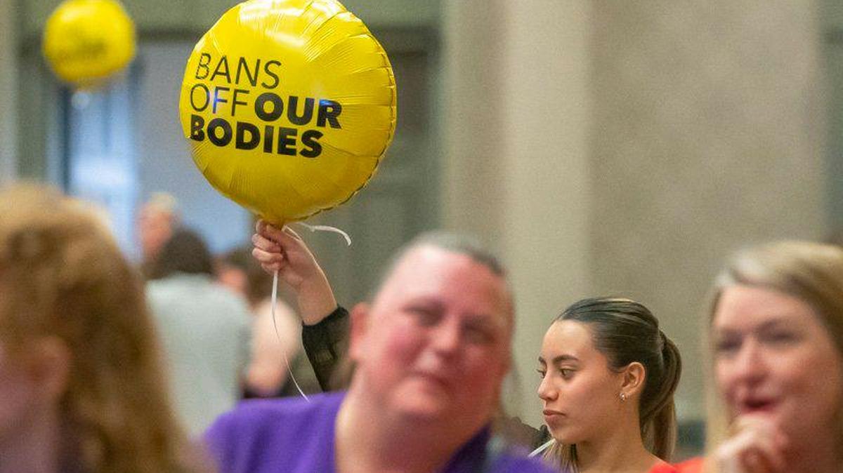 Sarah Gonzalez of Louisville holds a balloon at Protect Kentucky Access’ election watch party the Galt House in Louisville, Ky., on Tuesday, Nov. 8, 2022.