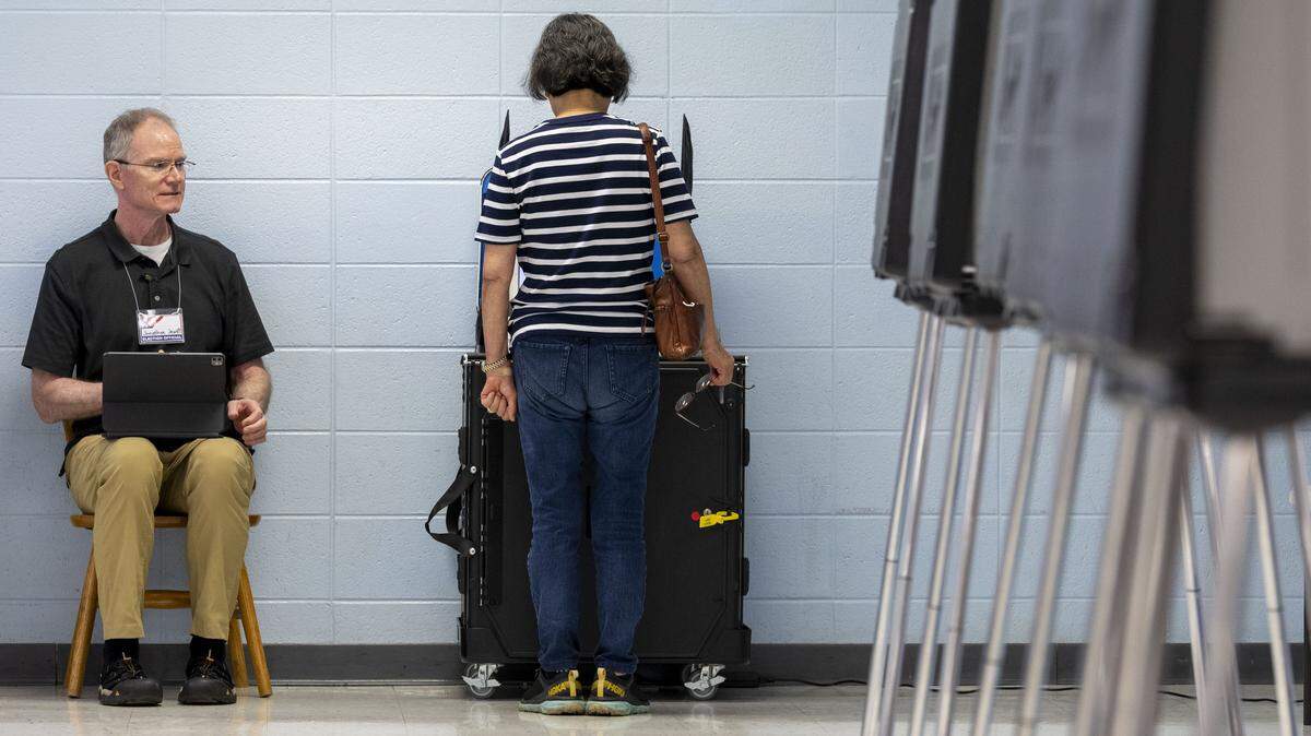 Precinct worker Jonathan Jewett watches as a voter casts their ballot in the 2026 primary election at Julius Marks Elementary School, May 19, 2026, in Lexington, Ky. Voters went the polls on primary election day across Kentucky to decide who will be on the ballot in November for major races across the commonwealth.