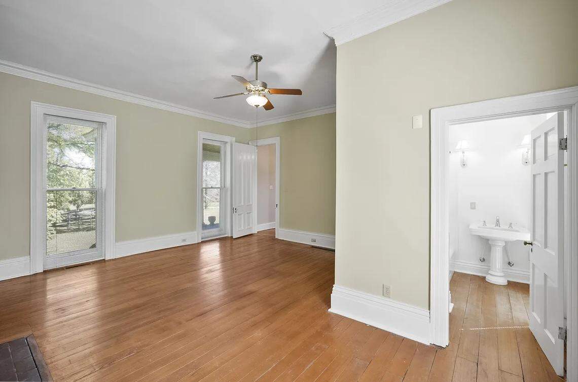A view of a downstairs, primary bedroom with an adjoining bathroom at 315 Heritage Road.