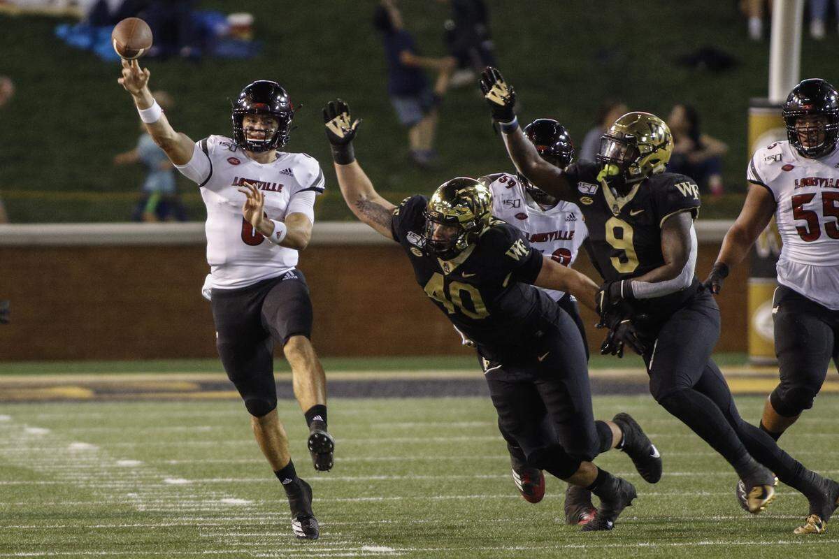 Louisville quarterback Evan Conley, left, threw for 196 yards and two touchdowns and ran for 79 yards and one score in U of L’s wild, 62-59 upset of No. 19 Wake Forest.