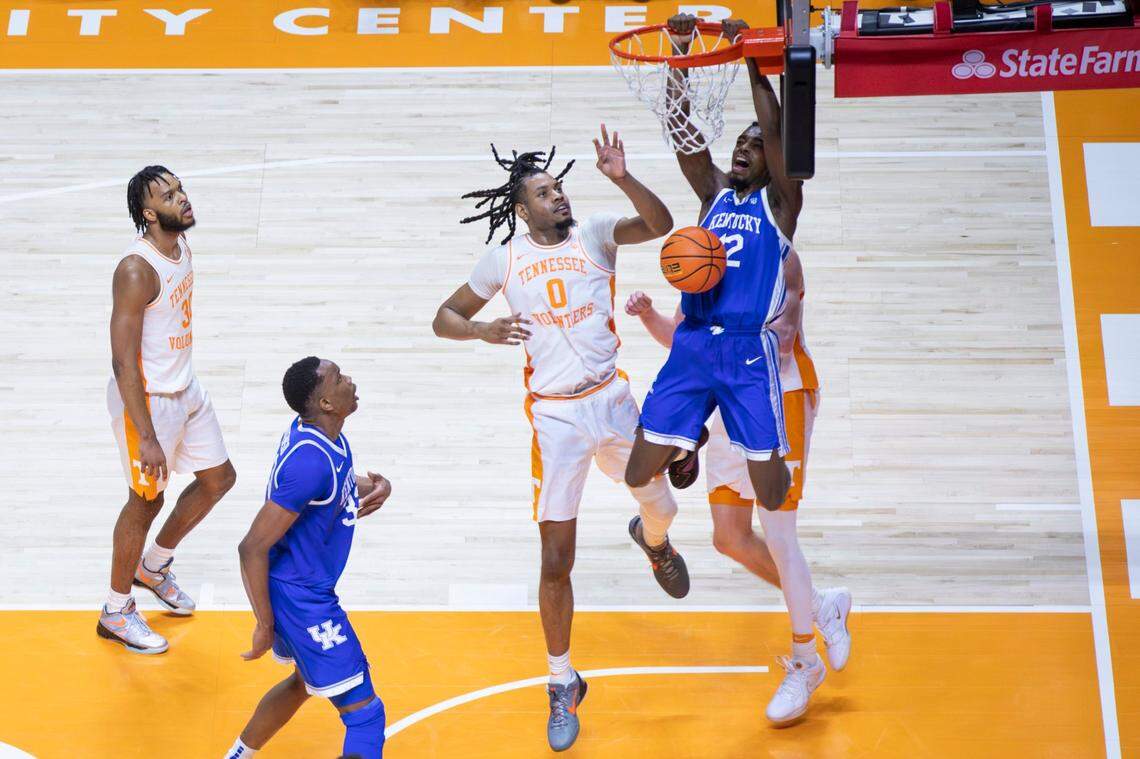 Kentucky Wildcats guard Antonio Reeves (12) dunks to score against Tennessee Volunteers forward Jonas Aidoo (0) during the game at Thompson-Boling Arena in Knoxville, Tn, Saturday, March 9, 2024.