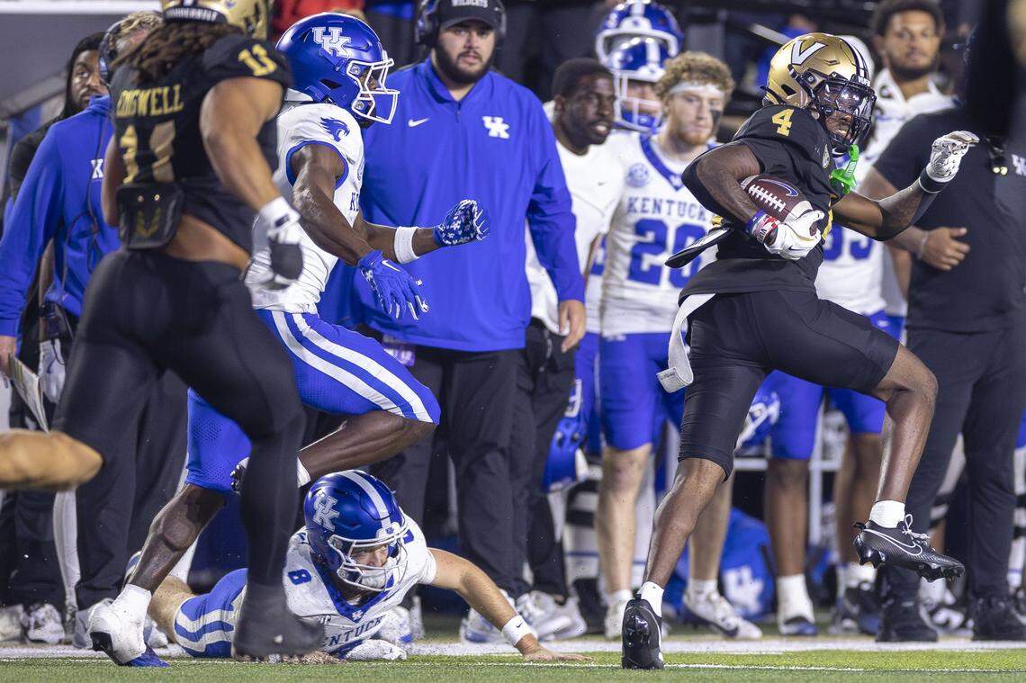 Kentucky quarterback Cutter Boley (8) looks on as Vanderbilt cornerback Martel Hight (4) runs back an interception during a game at FirstBank Stadium in Nashville on Saturday.