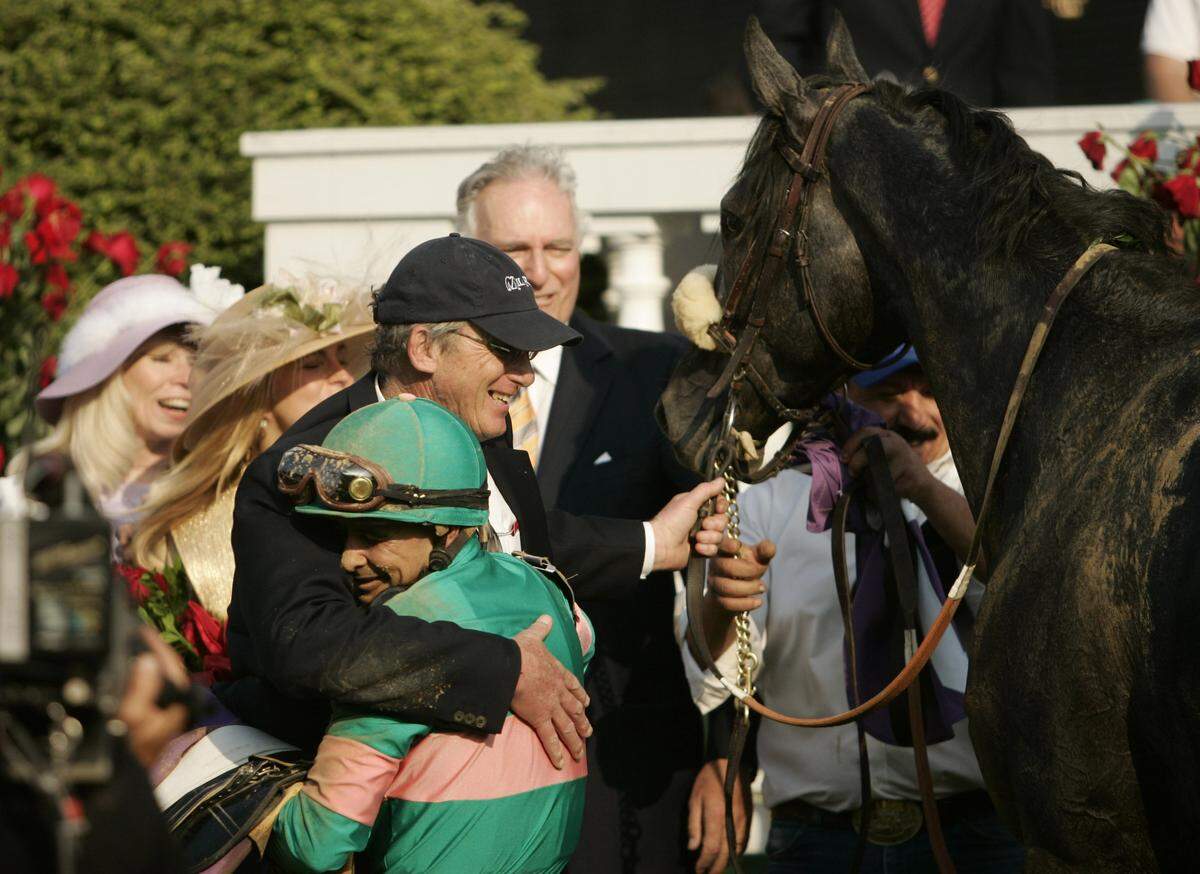 Jockey Mike Smith hugged trainer John Shirreffs in the winner's circle after winning the 2005 Kentucky Derby aboard longsot Giacomo.