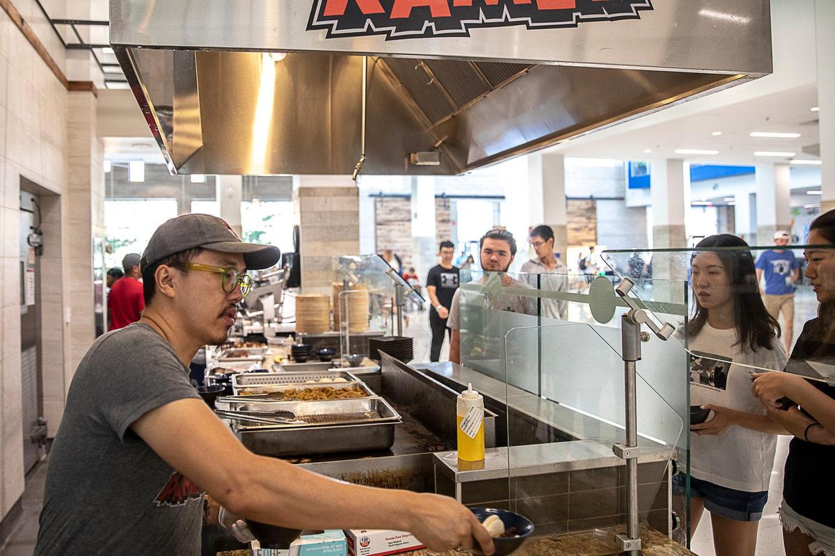Atomic Ramen’s Dan Wu serves bao buns at the eatery’s location at The 90 on the University of Kentucky campus. Wu said the arrangement has worked well for his restaurant.