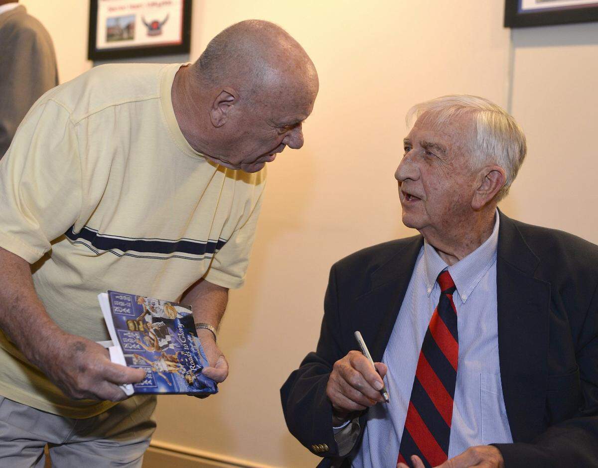 Vernon Hatton, right, speaks with Billy Baugh, during the induction ceremony for the Kentucky High School Athletic Association Basketball Hall of Fame at The State Theater in Elizabethtown in 2014.