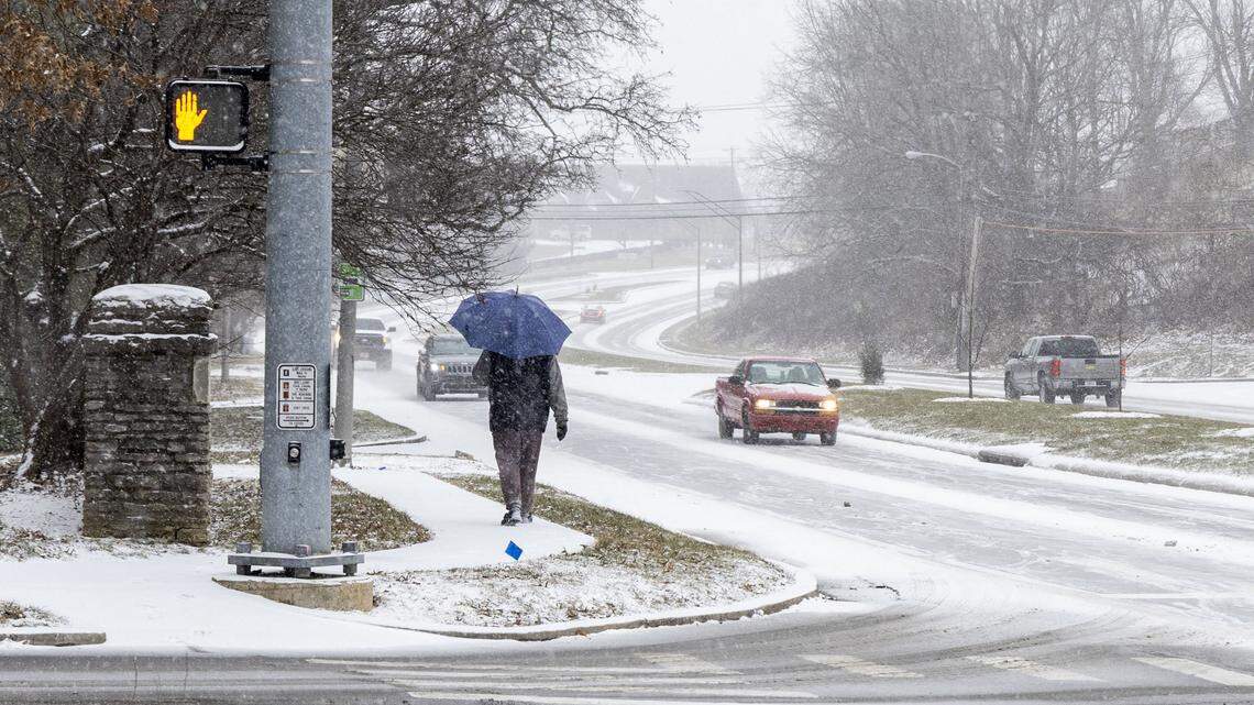 A pedestrian walks along Lexington’s Tates Creek Road, Jan. 24, 2026, as Winter Storm Fern starts to bring heavy snowfall and sleet across Lexington and Central Kentucky.