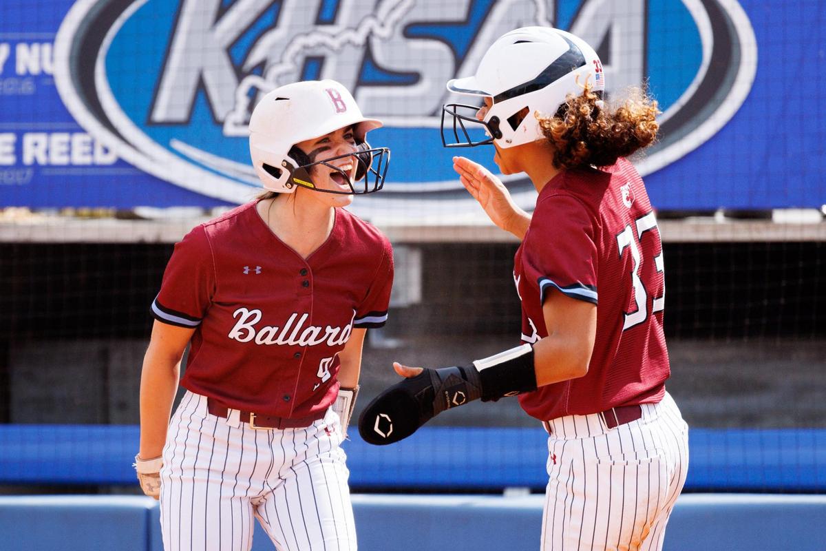 Ballard’s Emory Donaldson, left, celebrates with Mikayla Milby after Donaldson scored a run against South Warren in the state softball semifinals Saturday.